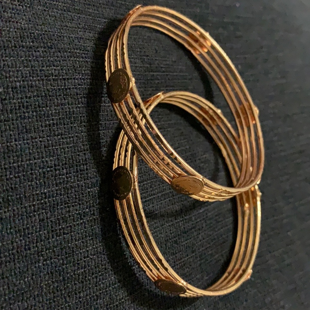 Gold tone bangles with Victorian logo